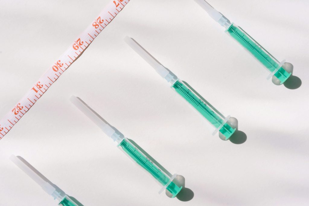 syringes next to a tape measure