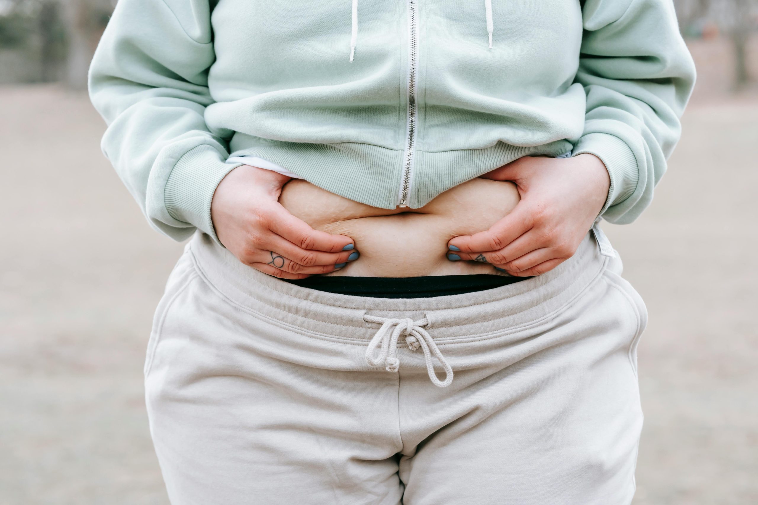 Overweight woman holding her belly