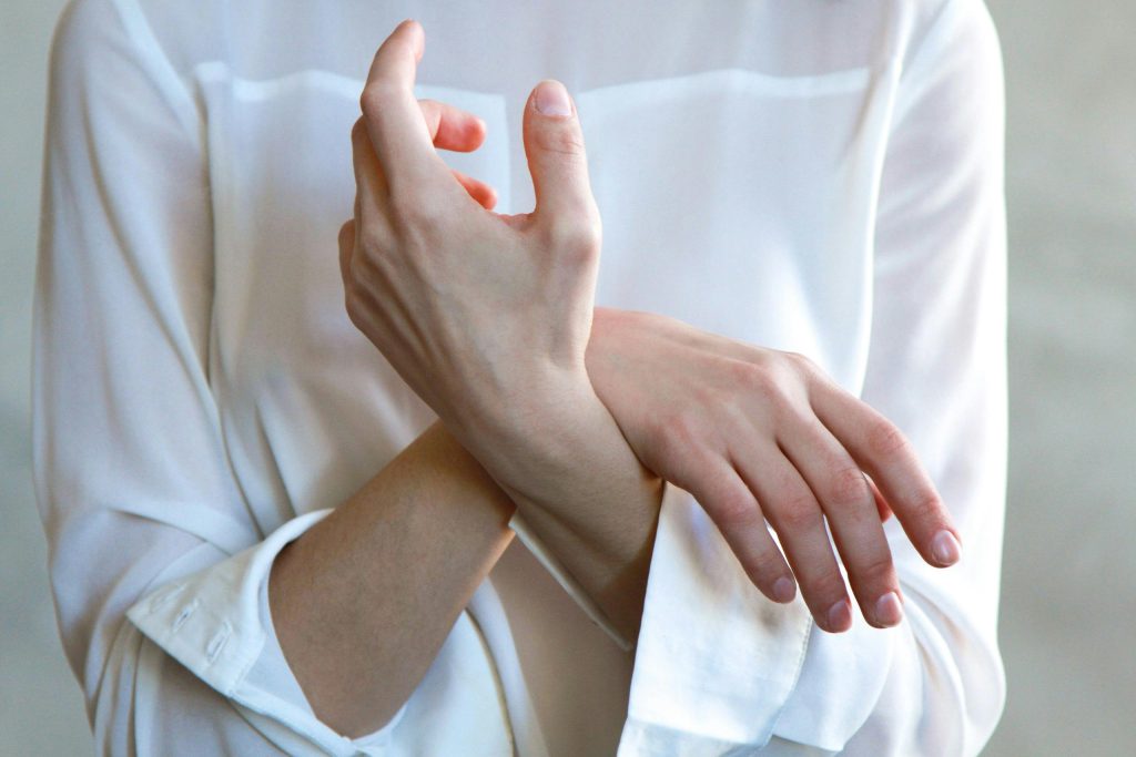 Person resting there wrist on their other arm