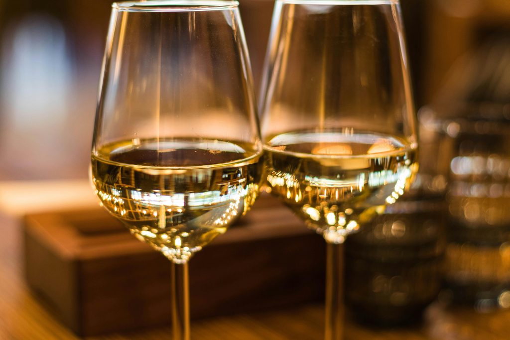 Two glasses of wine sitting next to each other