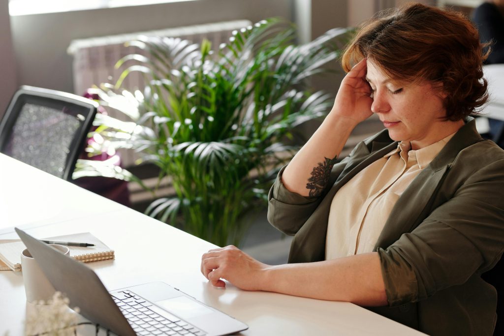 Woman holding her head from a headache