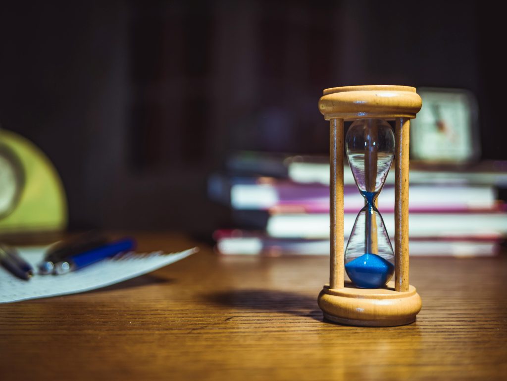 An hourglass sitting on a desk