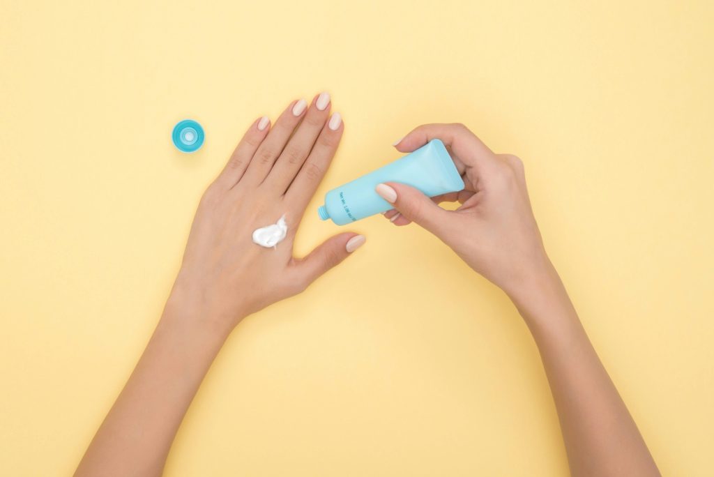 Person putting estrogen cream on their hand